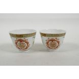 A pair of Chinese polychrome porcelain tea bowls decorated with bats and auspicious symbols, seal