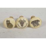 Three bone topped bottle corks with cat, dog and grape decoration, 2½" high