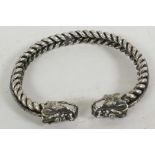A white metal twisted rope torque style bangle with dragon's head terminals, 2½" diameter