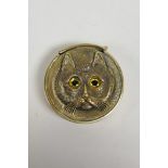 A brass vesta case with cat's head decoration, 1½" diameter