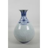 A Chinese blue and white porcelain pear shaped vase with a flared rim, decorated with birds