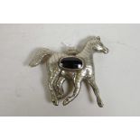 An Indo Persian white metal horse pendant set with a facet cut black stone, 6" x 5"