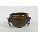 A Chinese copper censer with two drop handles held by four lion masks, cast marks to base, 4½"