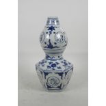 A Chinese blue and white porcelain double gourd vase with hexagonal base, decorated with gourds,