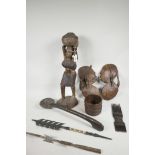 A collection of eight African artefacts to include carved hardwood figure, two hardwood silhouettes,
