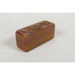 A Chinese amber soapstone box containing a soapstone seal, the cover with carved lotus flower