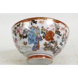 A Japanese Satsuma porcelain bowl painted with a continuous scene of figures in a floral garden,