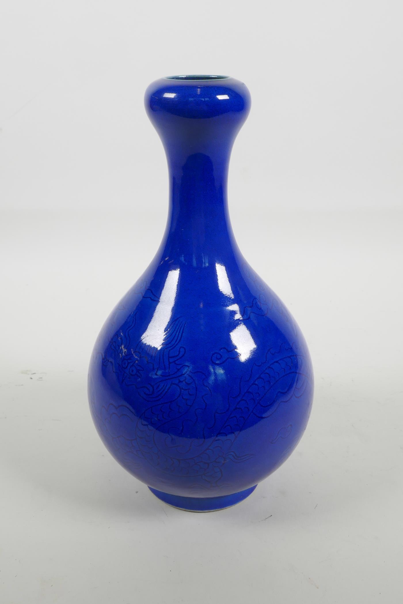 A Chinese blue glazed porcelain garlic head shaped vase with incised dragon decoration, 6