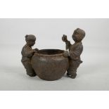 A Chinese iron censer with two handles in the form of children, impressed 4 character mark to