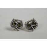 A pair of sterling silver owl shaped cufflinks