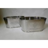 A pair of large chrome plated champagne buckets, decorated with engraved quotes by Lily Bolinger and