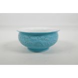 A Chinese blue glazed bowl with raised, stylised dragon decoration, impressed mark to base, 7"