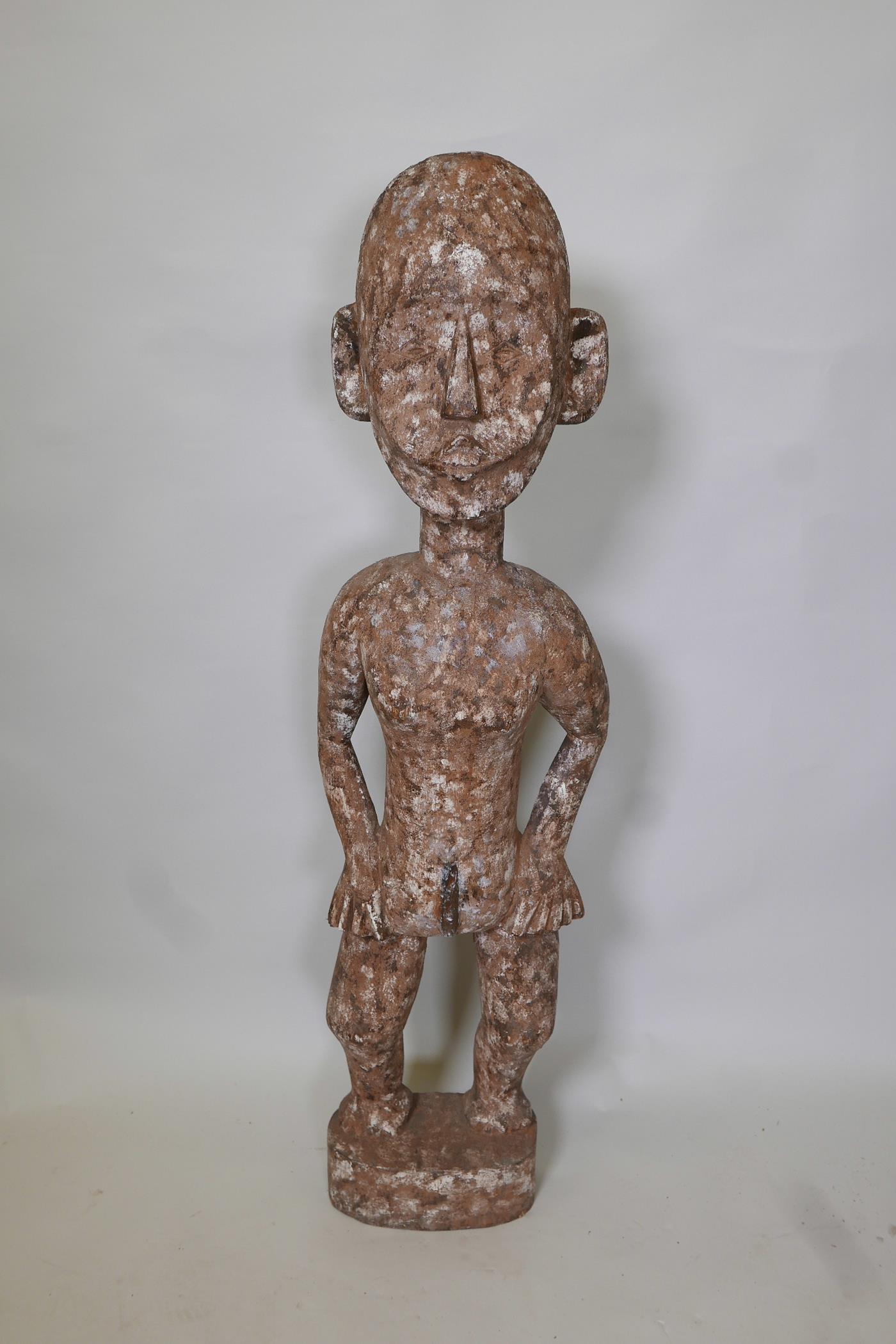 An African carved wood ethnic figure of a man, 40" high