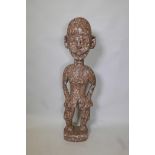 An African carved wood ethnic figure of a man, 40" high