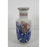 A Chinese porcelain Rouleau vase with blue and red decoration of mythical beasts, 14½" high