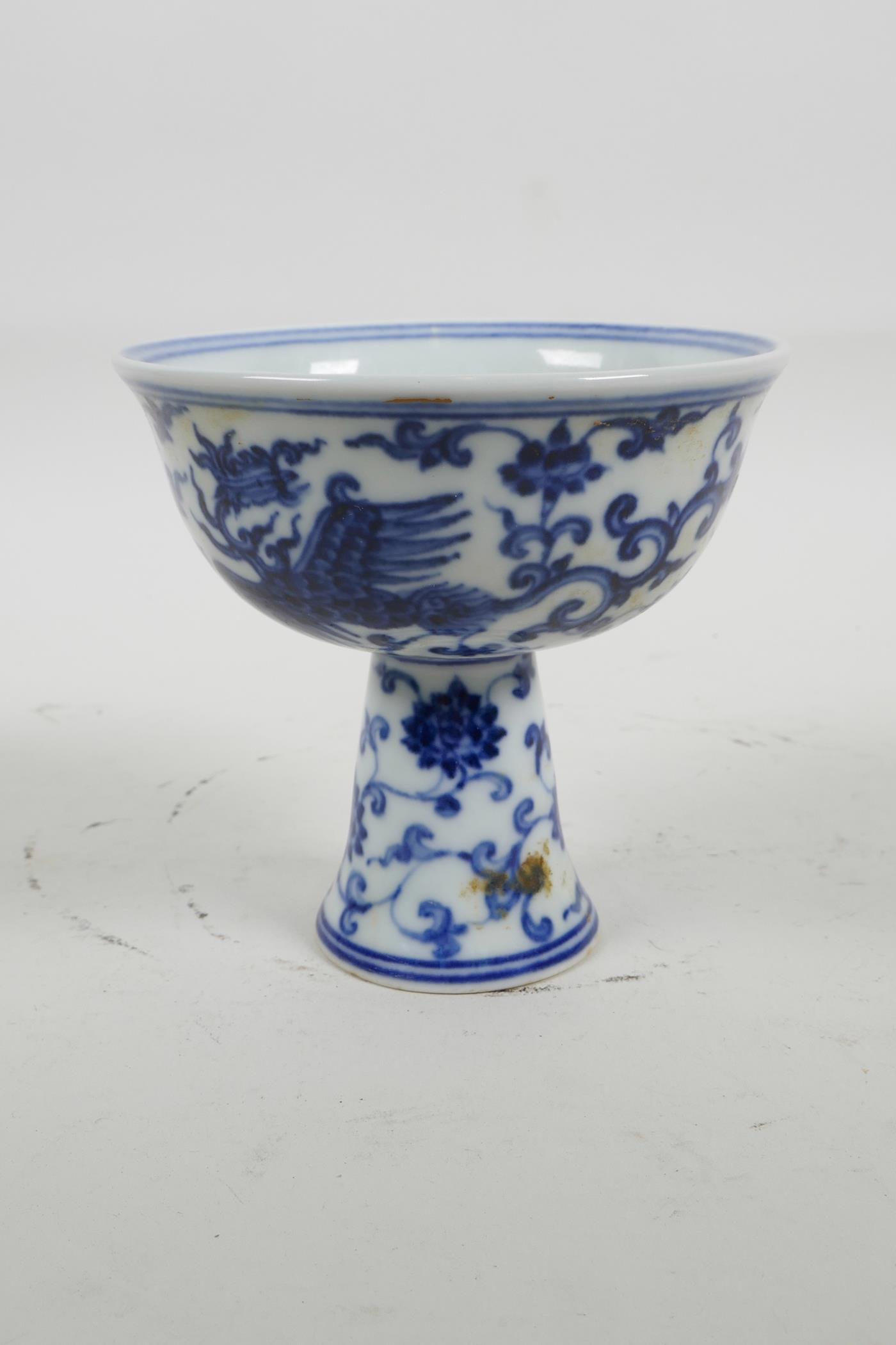 A blue and white porcelain stem bowl with phoenix decoration, 6 character mark to bowl