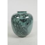 A Japanese porcelain green glazed baluster jar decorated in black with birds and branches, three