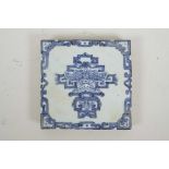 A Chinese blue and white porcelain tile decorated with a stylised bat and symbol, 8" x 8"