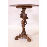 An C18th/19th carved pine putti table base, raised on scrolling tripod supports, later top, minor