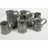A collection of pewter tankards, seven one-pint tankards and a one-quart tankard, many with C19th