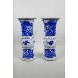 A pair of Chinese blue and white porcelain Gu shaped vases decorated with figures in landscape