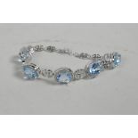 A silver, cubic zirconium and aquamarine set line bracelet, 6½" long