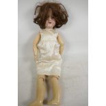An Armand Marseille doll with bisque head, no.390 A3M, having sleeping eyes and open mouth with four