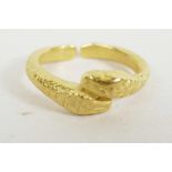 An antique yellow metal split ring with double snake head decoration
