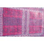 A Turkish hand woven wool carpet with traditional geometric designs on a red field, 60" x 83"