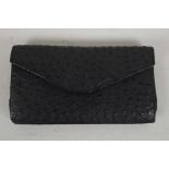 A Corbeau Curio ostrich skin clutch bag, 10" x 5"