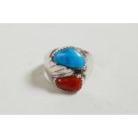 A heavy unmarked silver ring set with coral and turquoise, approximate size 'O'