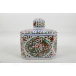 A Chinese polychrome porcelain tea canister decorated with red and green dragons chasing the flaming