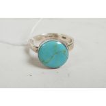 A Mexican silver ring set with a turquoise stone, approximate size 'V'