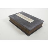 A Chinese hardwood and material bound book containing white jade tablet pages with engraved and gilt