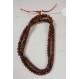 A string of horn mala beads, 43" long