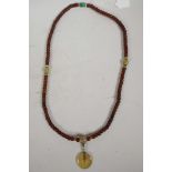 A string of horn mala beads with hardstone pi disc, 38" long