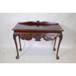 An Irish Georgian style mahogany side table with carved apron, raised on cabriole supports with ball