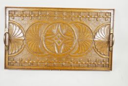 An Arts and Crafts carved oak serving tray with brass handles, 26" x 14½"