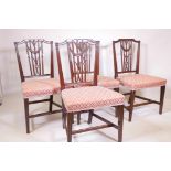 A set of four C18th mahogany Hepplewhite chairs, with carved and pierced reeded backs decorated with
