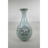 A Chinese Ming style celadon glazed porcelain pear shaped vase with pierced and reticulated panels