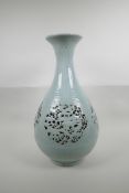 A Chinese Ming style celadon glazed porcelain pear shaped vase with pierced and reticulated panels