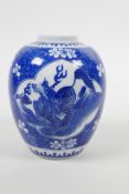 A Chinese blue and white porcelain jar with cracked ice decoration, with panels depicting kylin, six