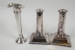 A pair of classical style Sheffield plated candlesticks with hexagonal columns on stepped square