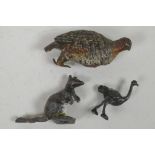 A cold painted bronze figurine of a grouse, 3" high, A/F, together with a small cast metal