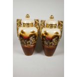 A pair of pastoral ware pottery urns and covers, with gilt handles and banded necks, transfer