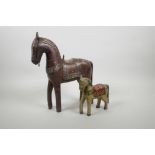 An Indian carved and painted wood horse, and another larger with white metal decoration, largest 12"