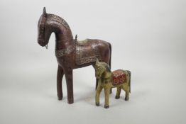 An Indian carved and painted wood horse, and another larger with white metal decoration, largest 12"