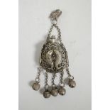 A Chinese pierced white metal scent holder pendant with carp and bell decoration, impressed