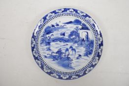 A Chinese blue and white plate decorated with figures engaged in various industries, fishing and