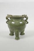 A Chinese olive crackle glazed pottery censer with two dragon handles and tripod supports, 6" high